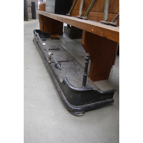2030 - A Victorian cast iron and brass fire kerb, 157cm