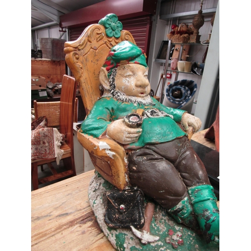 2035 - An early 20th Century reconstituted gnome sleeping in an armchair, pipe in hand