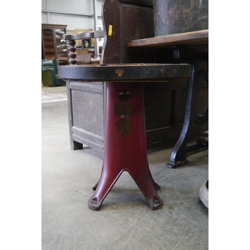 2002 - A circular oak topped table on industrial cast iron base, 56cm diameter