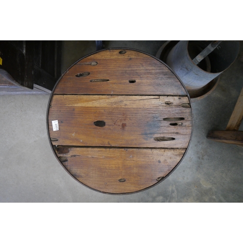 2002 - A circular oak topped table on industrial cast iron base, 56cm diameter