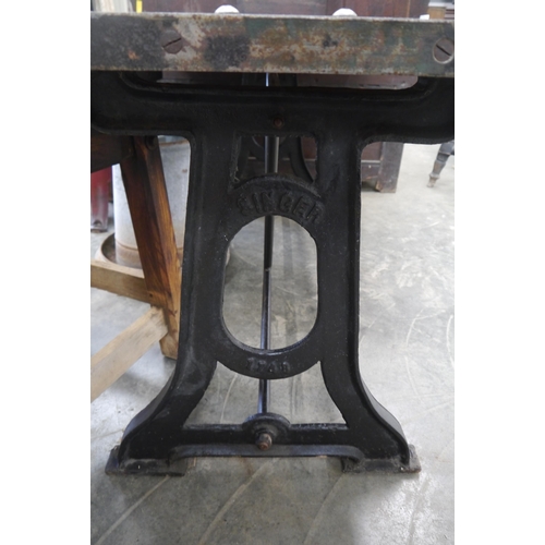 2010 - A large oak topped table on cast iron singer base, 178 x 87cm