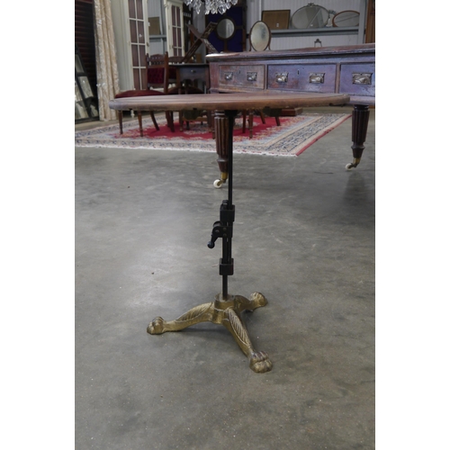2011 - An occasional height adjustable mahogany topped table on gilded three footed base
