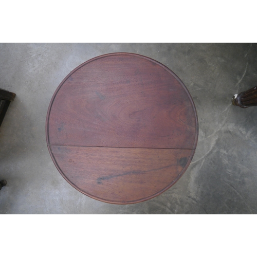 2011 - An occasional height adjustable mahogany topped table on gilded three footed base