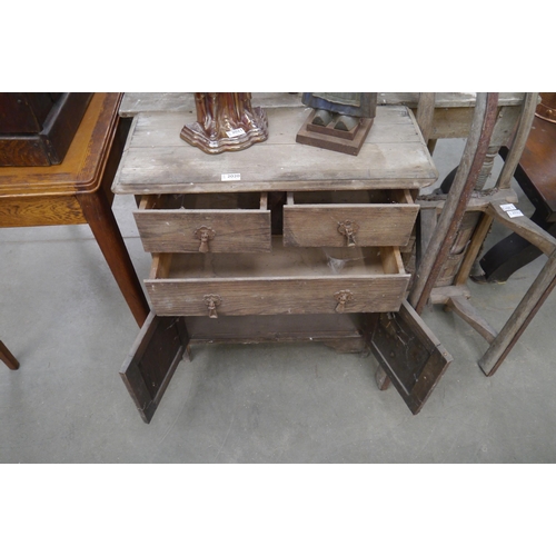 2020 - A small chest of drawers, two short and one long drawer over twin door base