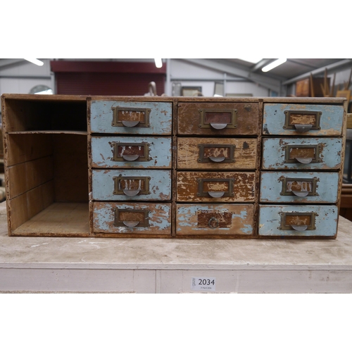2033 - A table top chest of 12 drawers