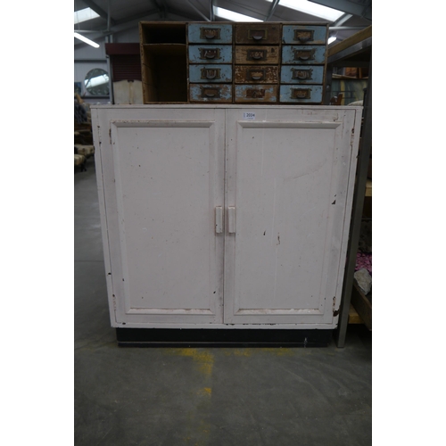 2034 - A 1930's two door cupboard painted white