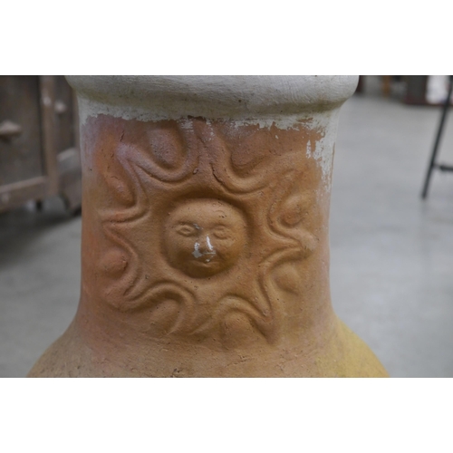 2067 - A small chimenea with sun motif and lid