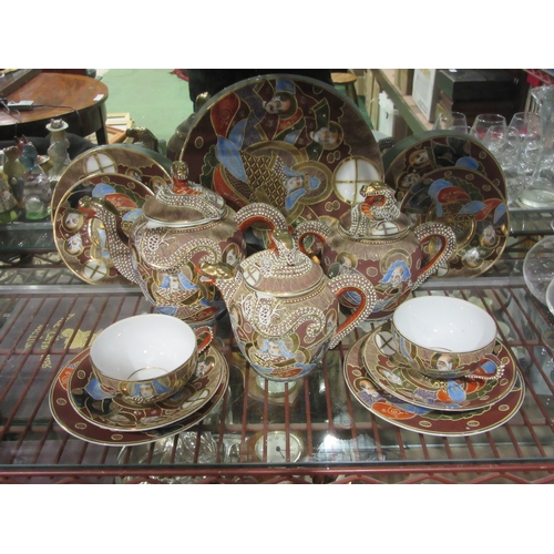 4392 - A part Japanese tea-set with Geisha girl to interior base, large plate, trios two teapots and a cove... 