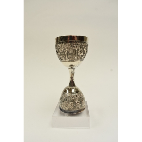 8022 - A two cup measure, marked silver with tribal hut and vegetation decoration, 10cm tall, 80g