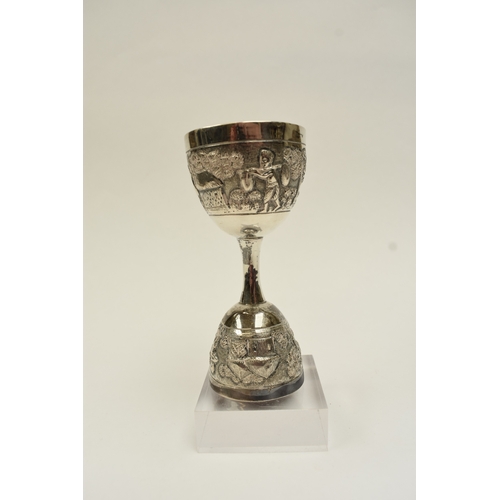 8022 - A two cup measure, marked silver with tribal hut and vegetation decoration, 10cm tall, 80g
