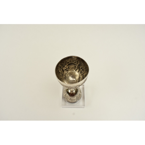 8022 - A two cup measure, marked silver with tribal hut and vegetation decoration, 10cm tall, 80g