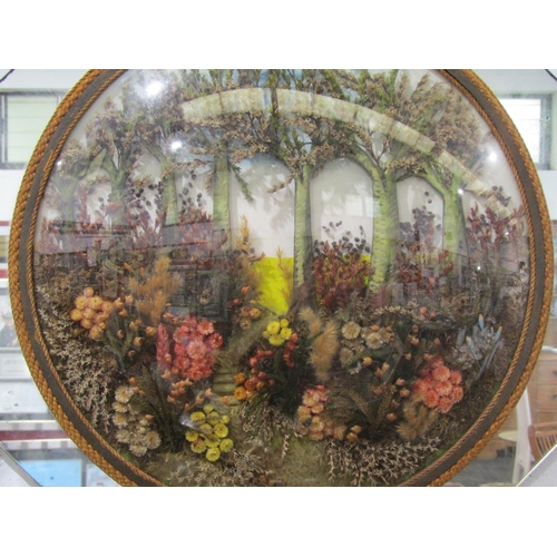 1072 - An unusual 1930's convex garden scene created with dried flowers in a mirrored frame, 45cm wide