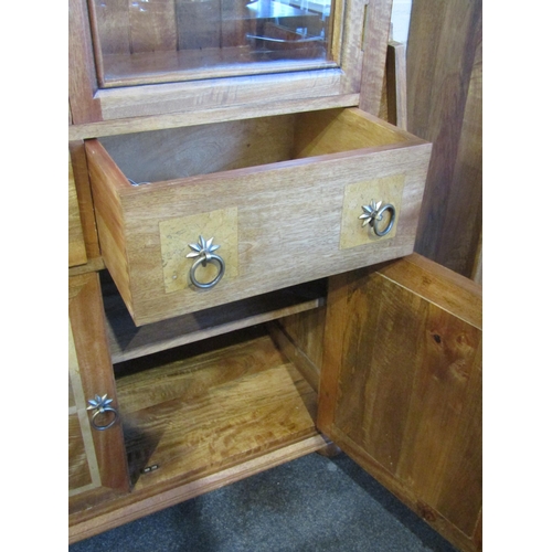 1013 - A Flagstone Furniture mango wood glazed display cabinet with stone inlay, two glazed doors and two d... 
