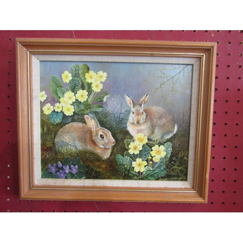 1067 - DENISE WORSDALL (local artist): An acrylic of two rabbits by flowers, signed lower right, framed, 18... 