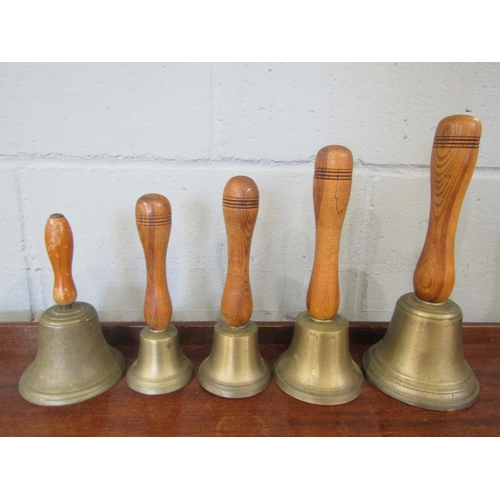 1076 - Five hand bells of various sizes, wooden handles