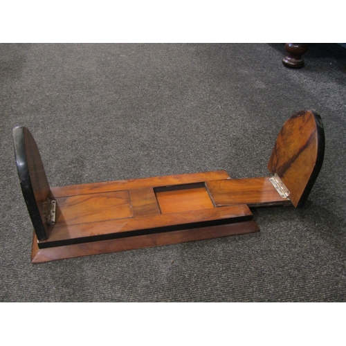 1080 - A walnut Gothic arch form bookslide with metal armorial mounts