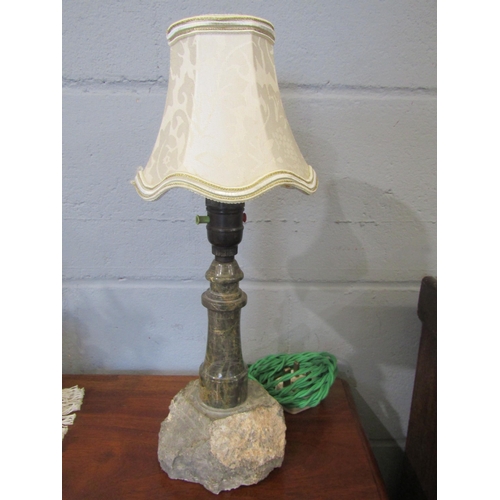 1085 - A turned and polished Cornish serpentine stone lamp in the form of a lighthouse on rocky outcrop, 38... 