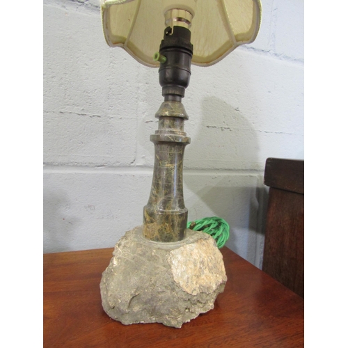 1085 - A turned and polished Cornish serpentine stone lamp in the form of a lighthouse on rocky outcrop, 38... 