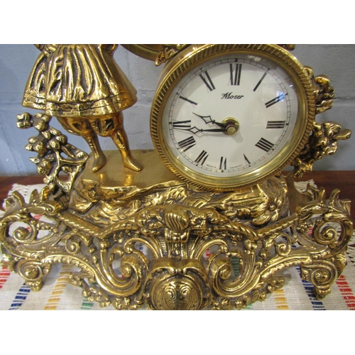 1086 - A Mozer brass mantel clock with a woman holding a flame, battery operated
