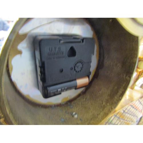 1086 - A Mozer brass mantel clock with a woman holding a flame, battery operated