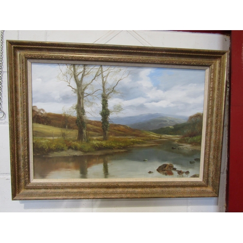 1088 - JOHN TRICKETT (b.1952): An oil on canvas of riverside scene, gent fishing with mountains to backgrou... 