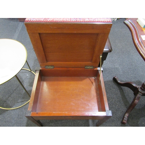 1110 - A 20th Century stool with rising lid, upholstered in floral fabric, satin wood inlay