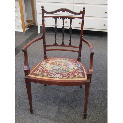 1114 - An Edwardian inlaid mahogany lady's armchair with carved acanthus detail to back rail and arms, tape... 