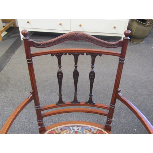 1114 - An Edwardian inlaid mahogany lady's armchair with carved acanthus detail to back rail and arms, tape... 
