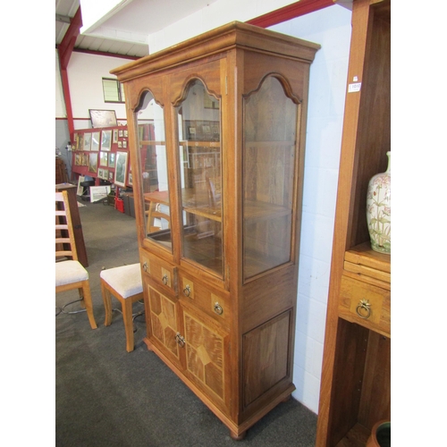 1013 - A Flagstone Furniture mango wood glazed display cabinet with stone inlay, two glazed doors and two d... 