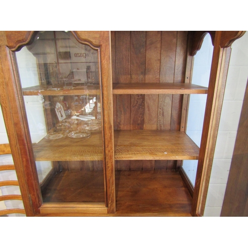 1013 - A Flagstone Furniture mango wood glazed display cabinet with stone inlay, two glazed doors and two d... 