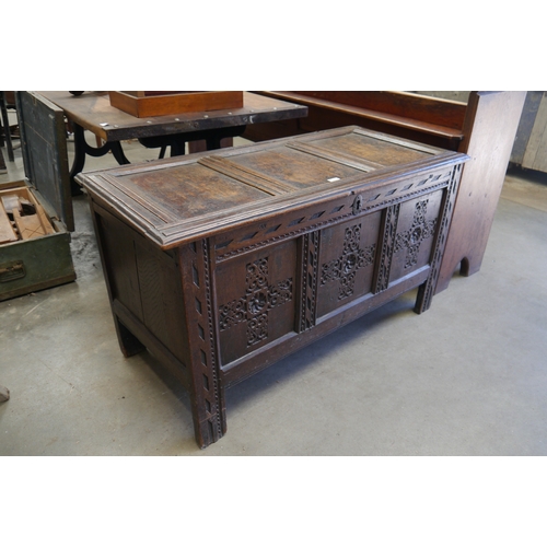 2001 - An 18th Century carved oak panelled coffer, 122cm