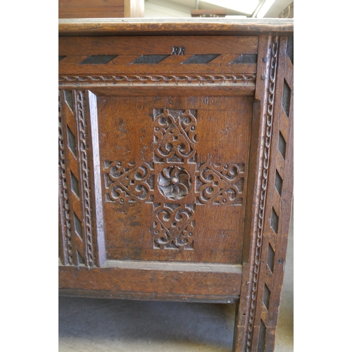 2001 - An 18th Century carved oak panelled coffer, 122cm