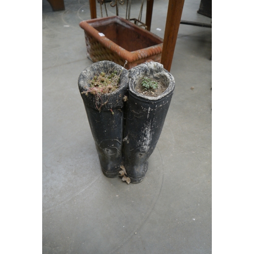 2014 - A composition planter of Wellington boots