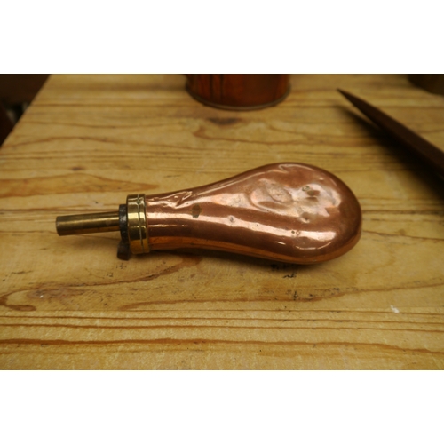 2040 - A brass and copper powder flask with military crest