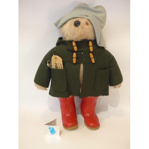 7074 - A 1970s Gabrielle Designs Paddington teddy bear, in red Wellington boots and green coat, some moth d... 