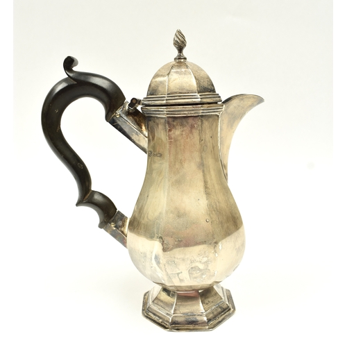 8011 - A George V silver small hot water jug in the 18th Century style, of pedestal panelled baluster form ... 