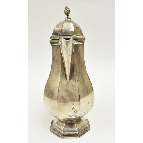 8011 - A George V silver small hot water jug in the 18th Century style, of pedestal panelled baluster form ... 