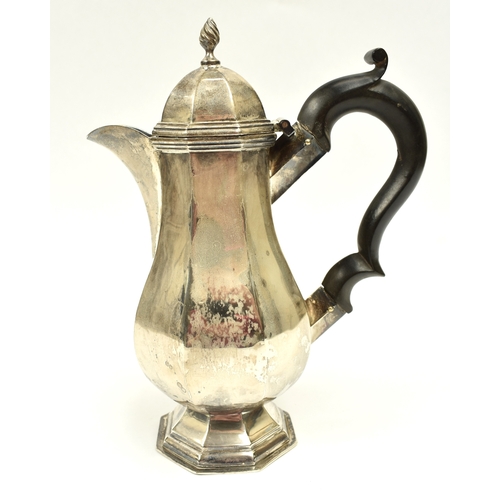 8011 - A George V silver small hot water jug in the 18th Century style, of pedestal panelled baluster form ... 