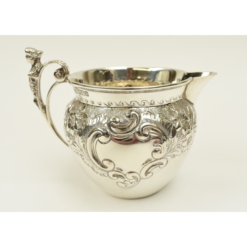 8017 - A Roberts & Belk silver cream jug with figural c-scroll handle, floral spray detail, Sheffield 1902,... 