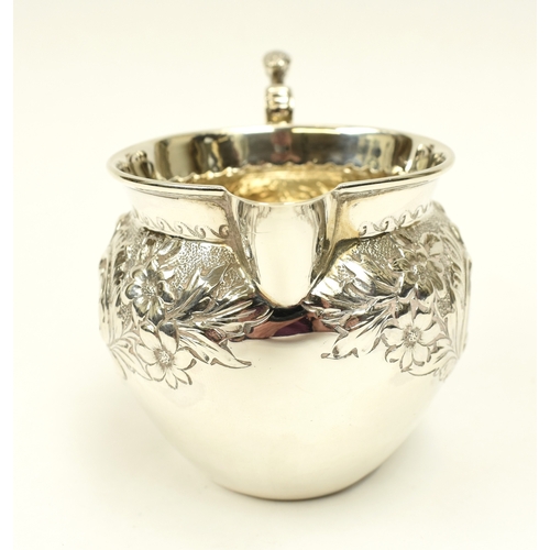 8017 - A Roberts & Belk silver cream jug with figural c-scroll handle, floral spray detail, Sheffield 1902,... 