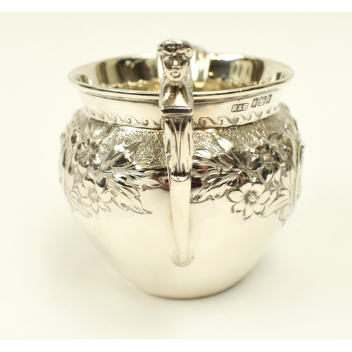 8017 - A Roberts & Belk silver cream jug with figural c-scroll handle, floral spray detail, Sheffield 1902,... 