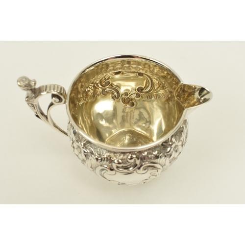 8017 - A Roberts & Belk silver cream jug with figural c-scroll handle, floral spray detail, Sheffield 1902,... 