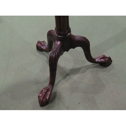 4035 - A Georgian mahogany torchere stand, the circular top over a pillar column on an acanthus leaf carved... 