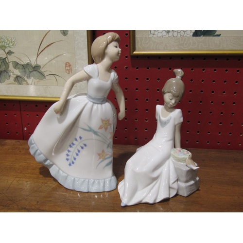 4022 - Four Nao figures including a girl with tennis racket and dog and a girl with bird