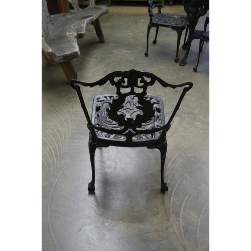 2009 - A cast iron based pub table and four alloy garden chairs