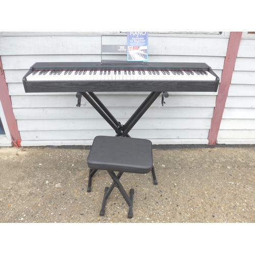 6093 - A Mustar digital piano, boxed with stand, seat, cover and sheet music book