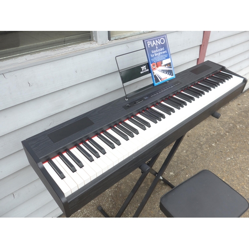6093 - A Mustar digital piano, boxed with stand, seat, cover and sheet music book