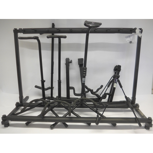 6064 - A folding nine position guitar rack stand and eight other guitar stands (9)