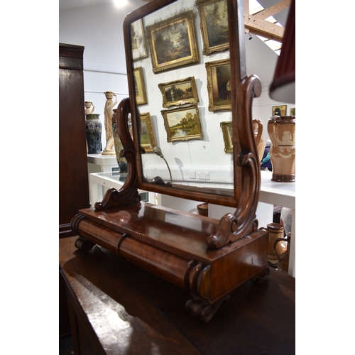 4011 - A mid-Victorian circa 1860 mahogany toilet mirror, the carved scroll supports on a two cushion drawe... 