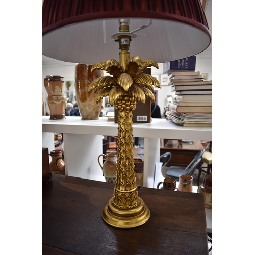 4042 - A gilt painted palm tree style table lamp with shade, 68cm tall